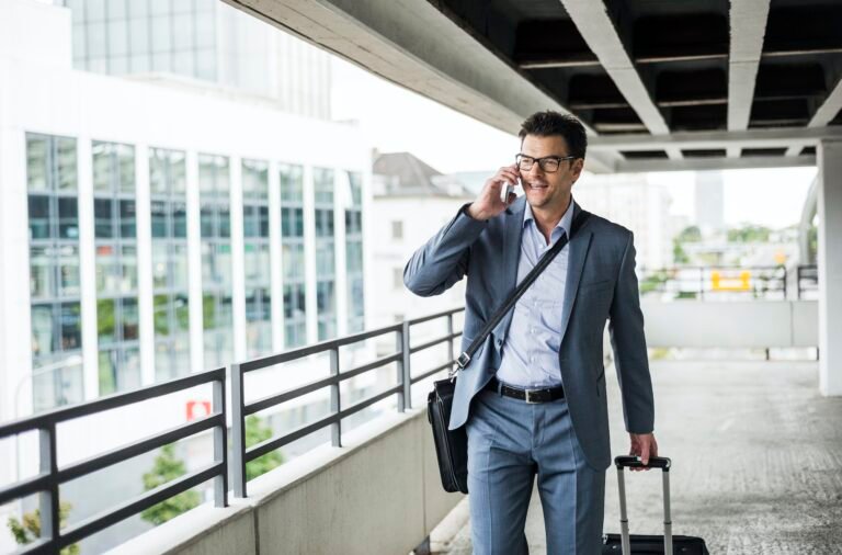 Businessman on business trip telephoning with smartphone